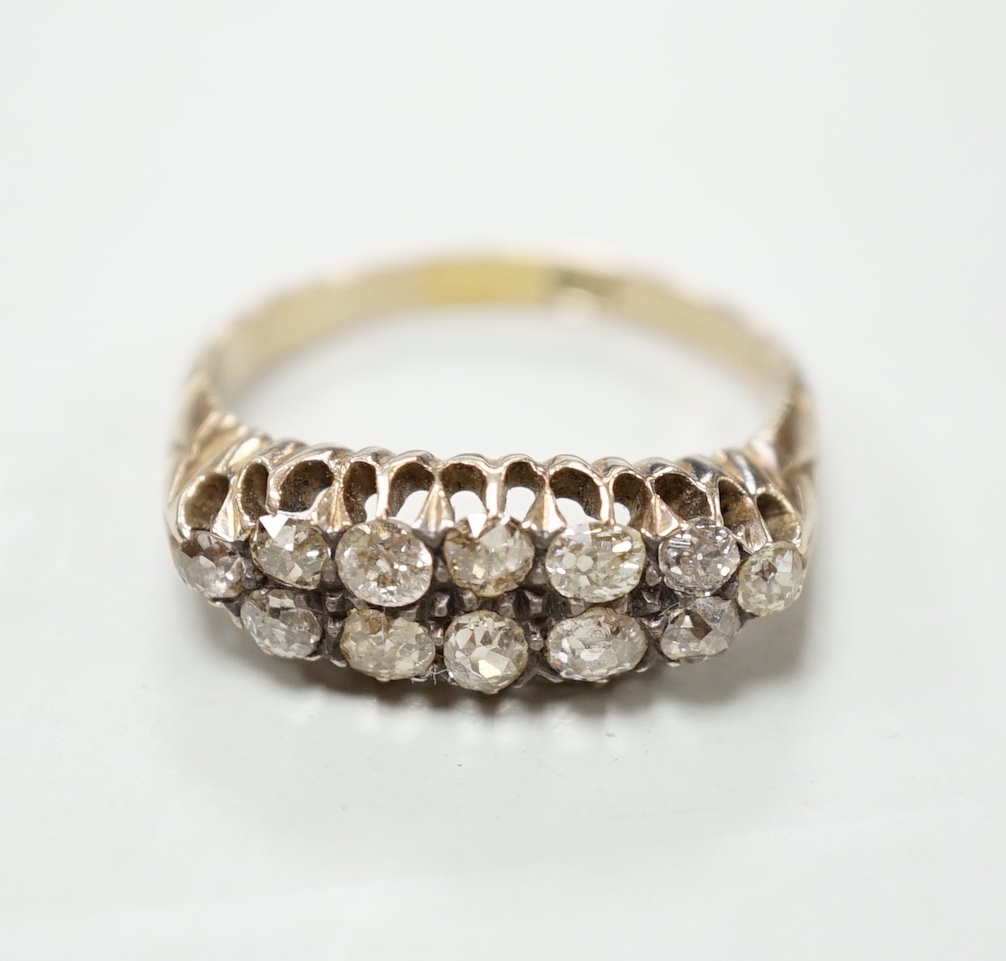 An 18ct and two row diamond cluster set half hoop ring, size R, gross weight 4.6 grams.